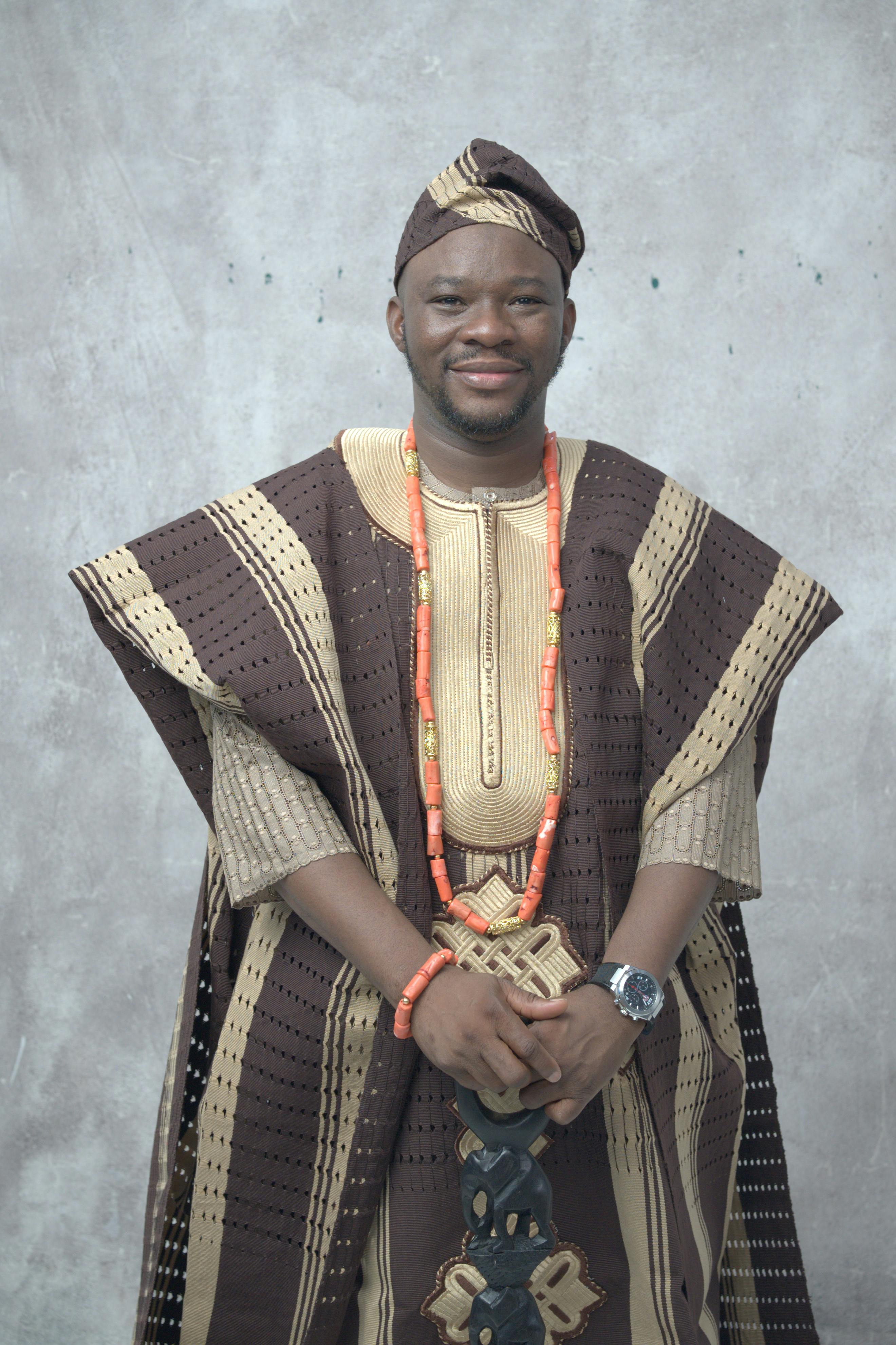 Man in traditional Nigerian agbada attire, showcasing culture