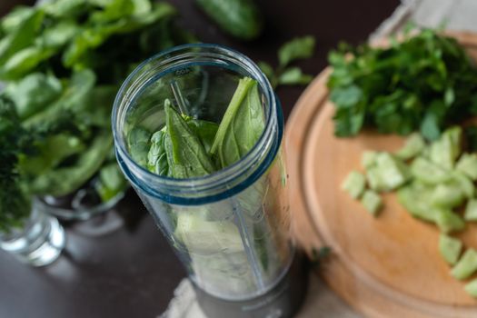 Top view of fresh green ingredients in a blender ready for a nutritious smoothie.