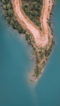 A stunning aerial shot capturing a peninsula surrounded by turquoise waters, located in İzmir, Türkiye.
