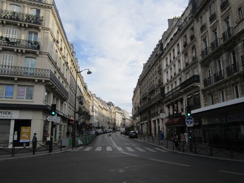 Free Street view of Paris showcasing classic 19th-century architecture on a sunny day, ideal for travel and tourism imagery. Stock Photo