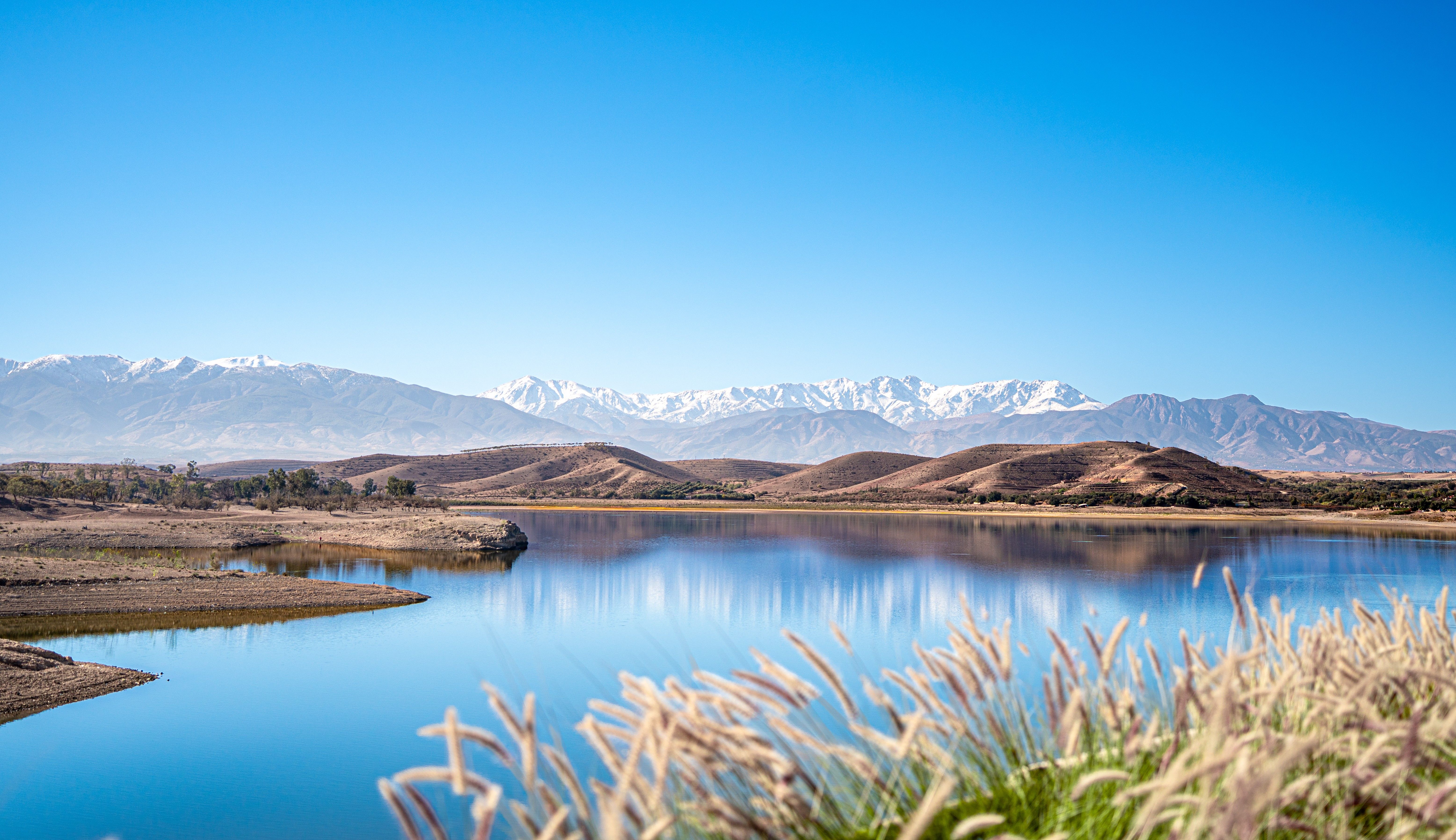 Lalla Takerkoust reservoir lake with the snow-capped High Atlas Mountains in the background