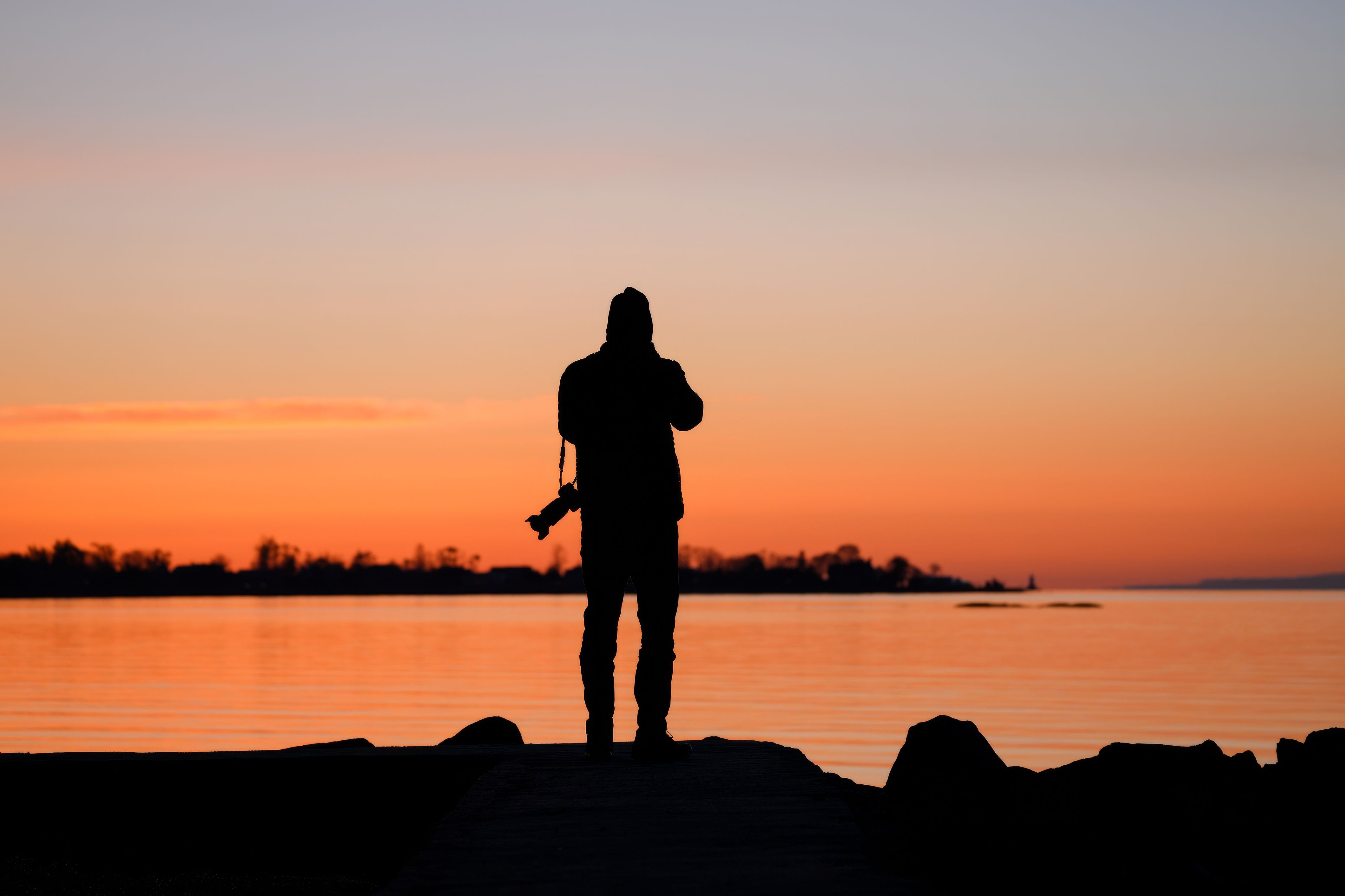 Silhouette of Photographer at Sunset by Lake · Free Stock Photo