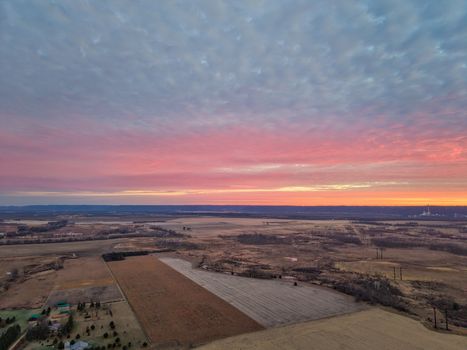 A breathtaking aerial shot of the rural landscape in Nelson, Wisconsin during a vibrant sunset.