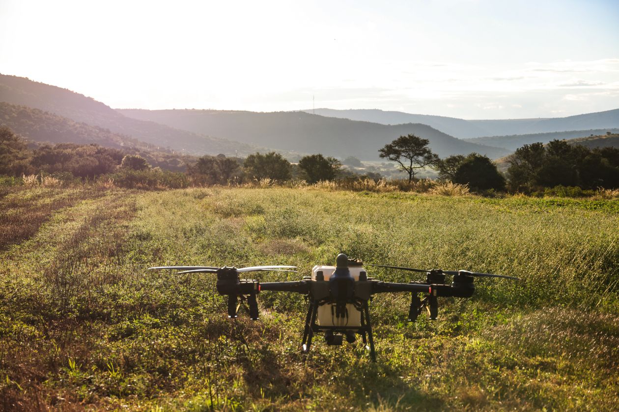 Drone flying over agricultural fields collecting methane data
