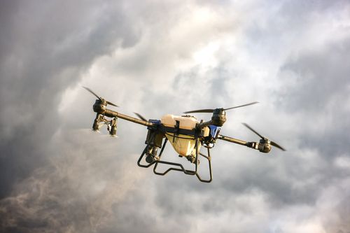 Free High-tech drone flying amidst dramatic cloudy skies, showcasing advanced technology. Stock Photo