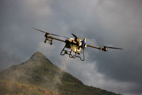 Free Aerial drone hovering over a scenic, mountainous landscape beneath cloudy skies. Stock Photo
