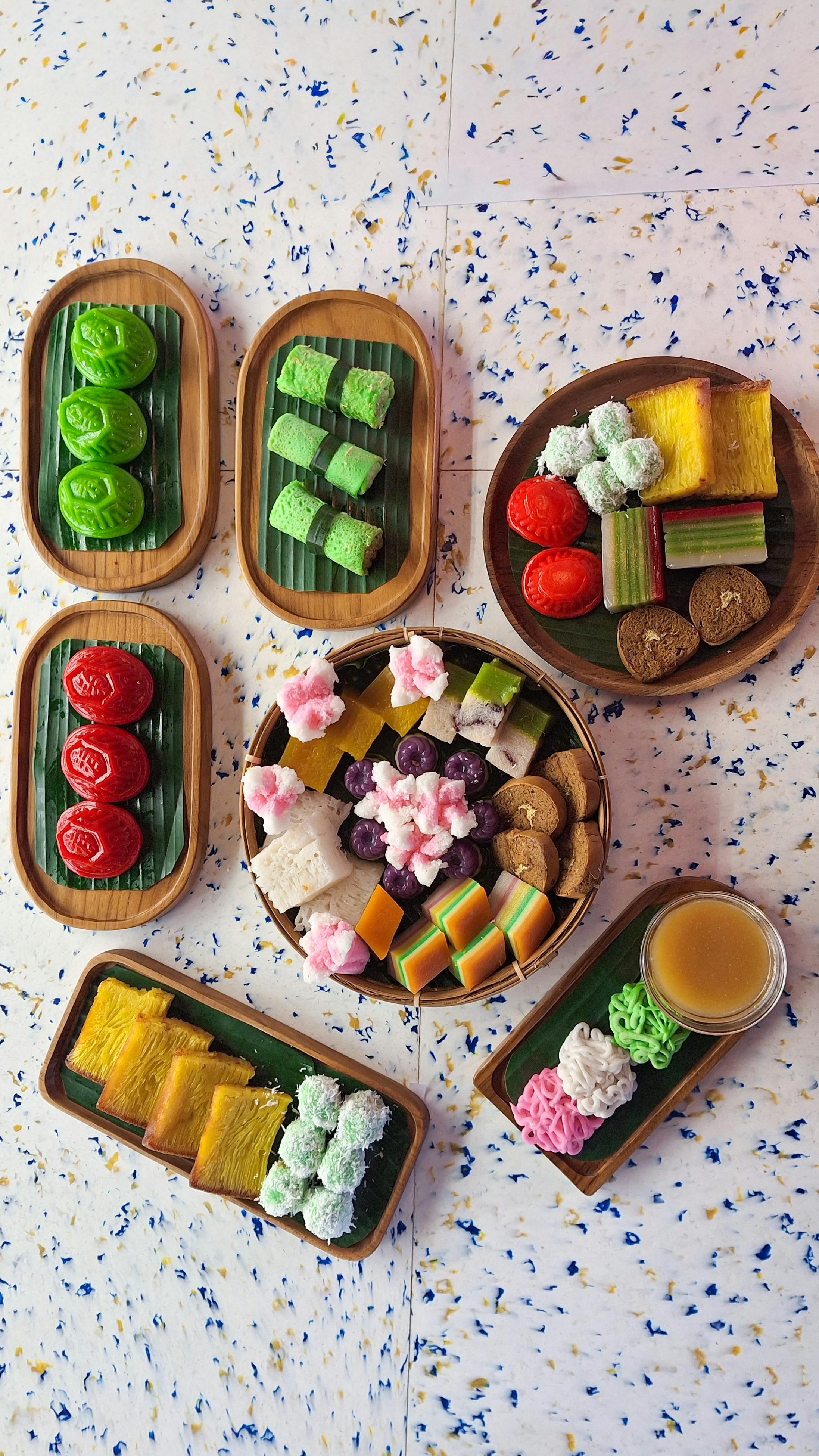 Assortment of colourful Nyonya kueh traditional Peranakan cakes served on a ceramic plate in Singapore