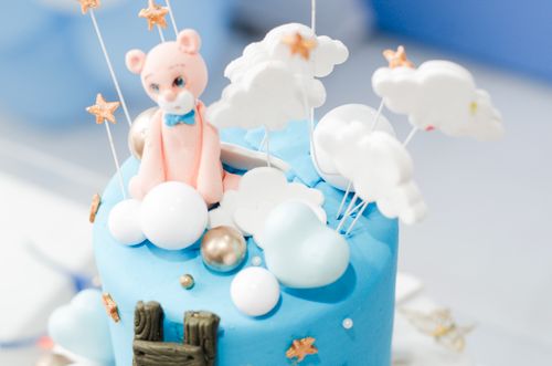 Free Charming cake decorated with blue fondant, teddy bear, clouds, and star accents, perfect for a children's party. Stock Photo