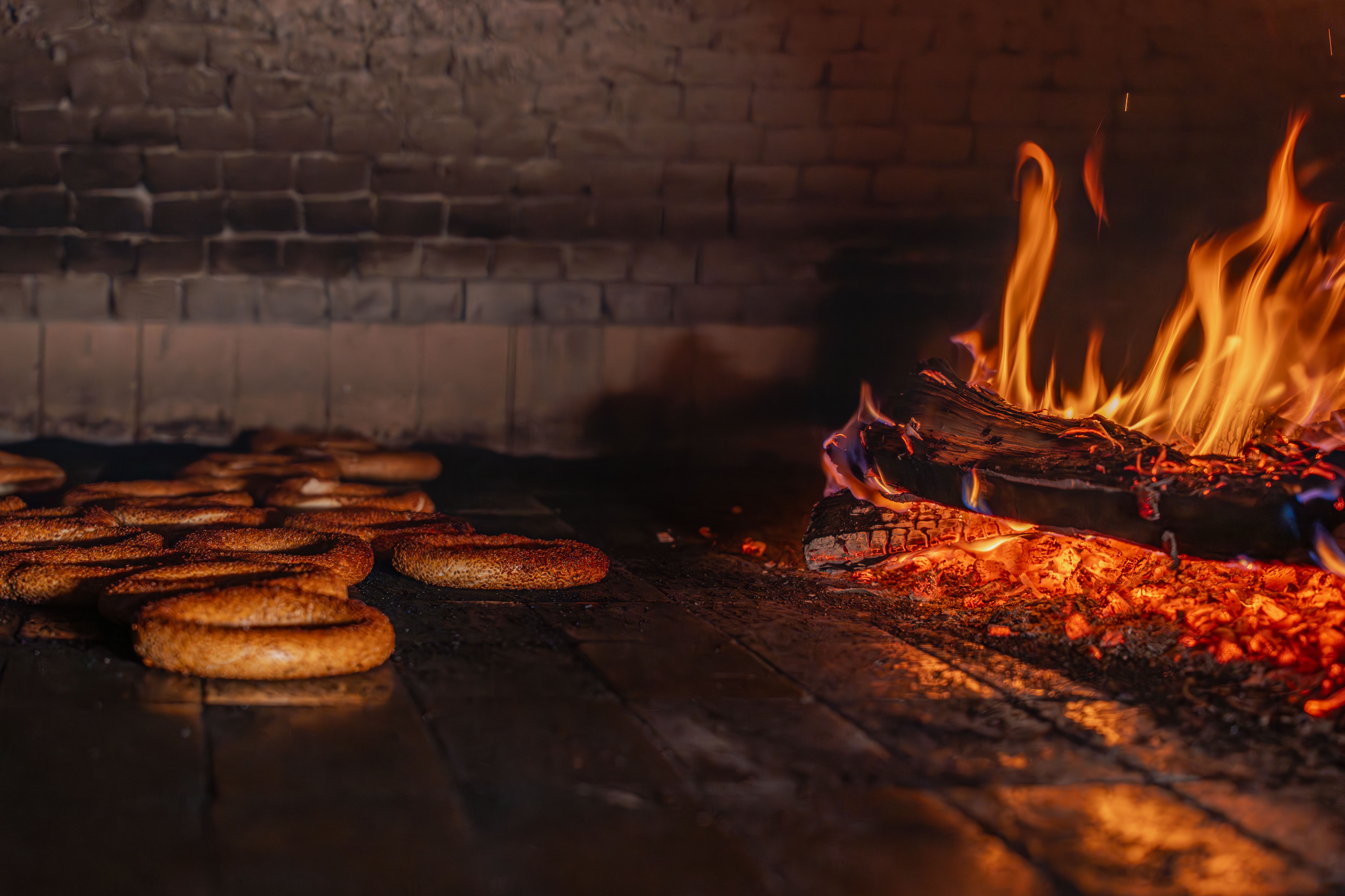 Wood-fired brick oven in a Castilian asador with clay dishes of suckling pig