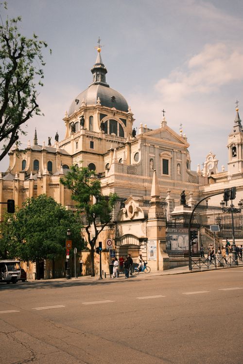 Free Elegant architectural capture of Almudena Cathedral under a bright sky, showcasing its historic charm in Madrid, Spain. Stock Photo