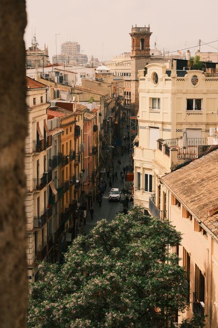 A bustling narrow street lined with historic buildings in a cityscape, perfect for travel and architecture themes.
