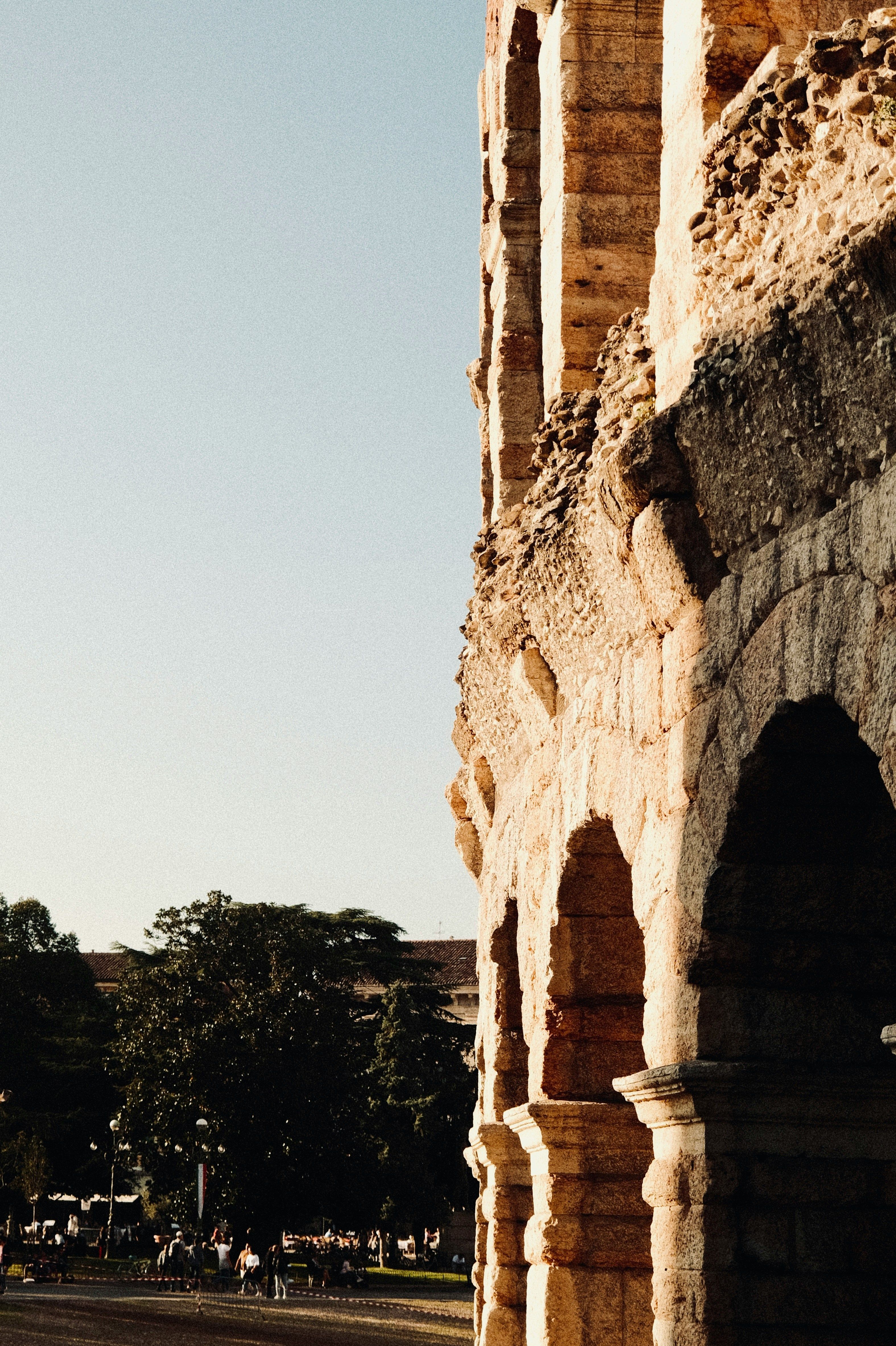 Historic Verona Arena under golden sunlight, highlighting its ancient Roman architecture.