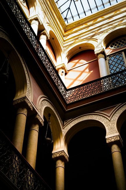 Sunlit arches and shadows in a historic Lisbon building.