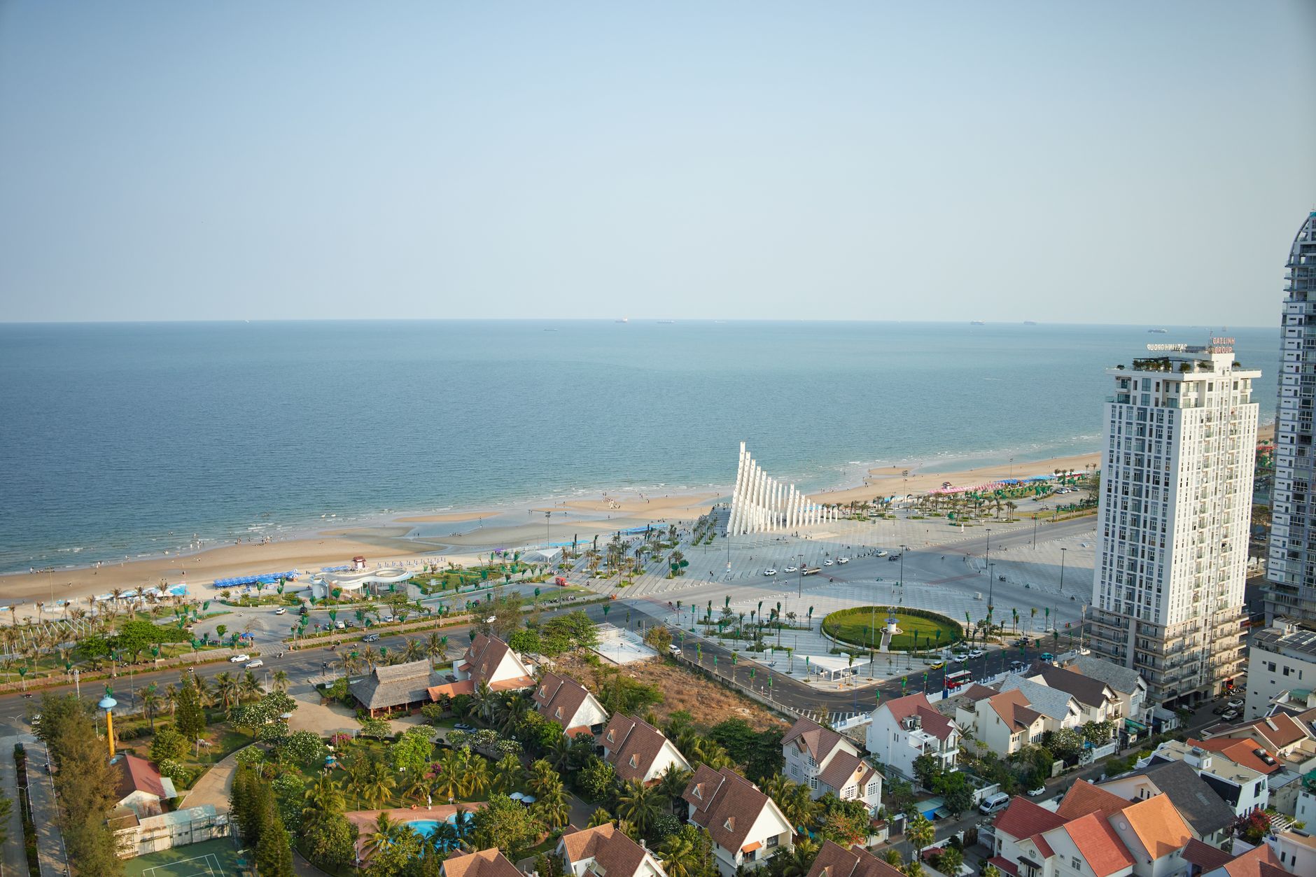 Aerial view of Ho Chi Minh City's coastline with modern architecture and expansive beaches.