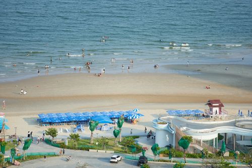 Free A scenic aerial view of a beach in Ho Chi Minh City with umbrellas and tourists enjoying the summer day. Stock Photo