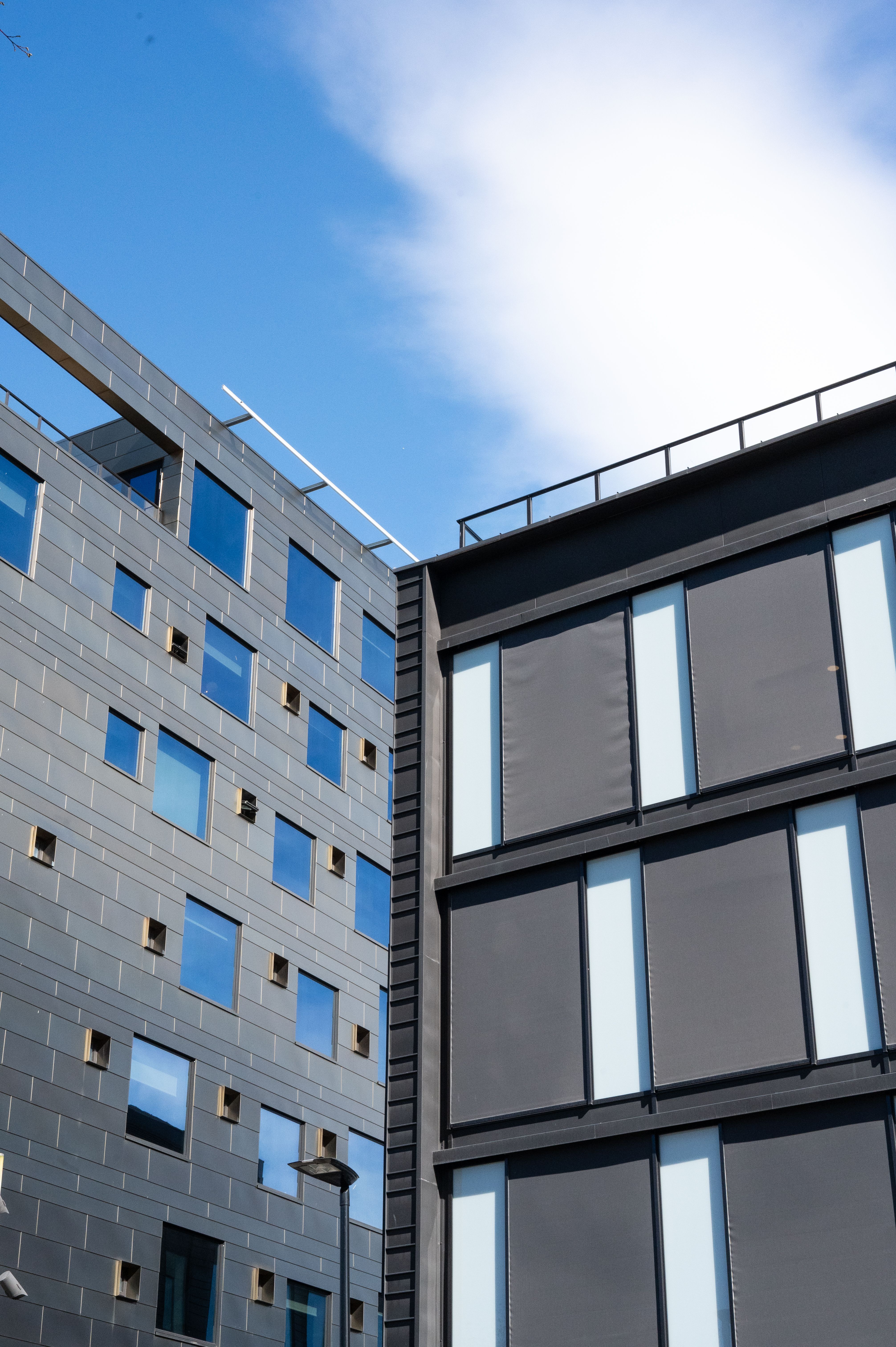 Modern Architectural Facade Under Blue Sky · Free Stock Photo