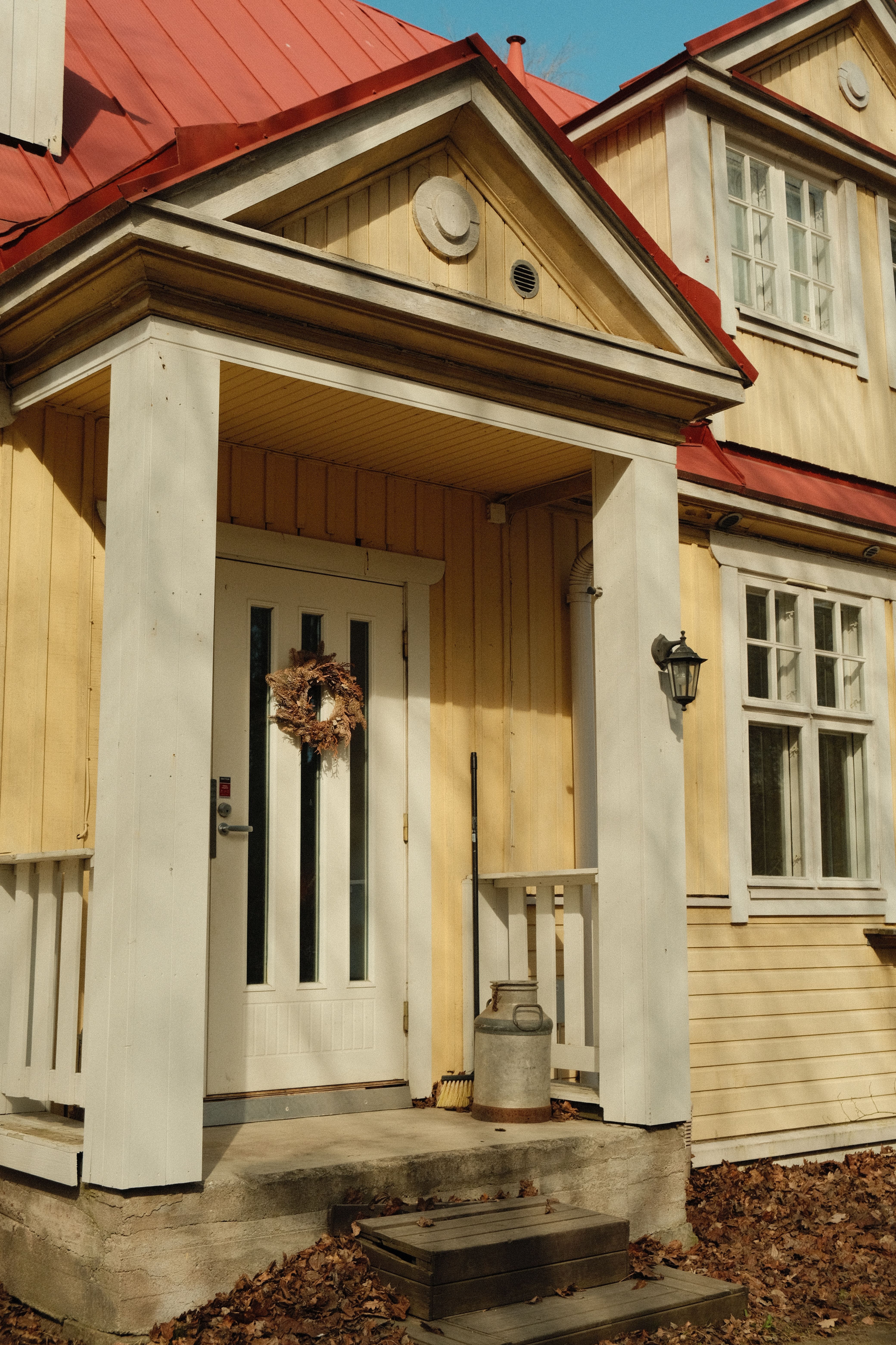 Charming wooden house entrance with a wreath in Lahti, Finland. Perfect for cozy home designs.