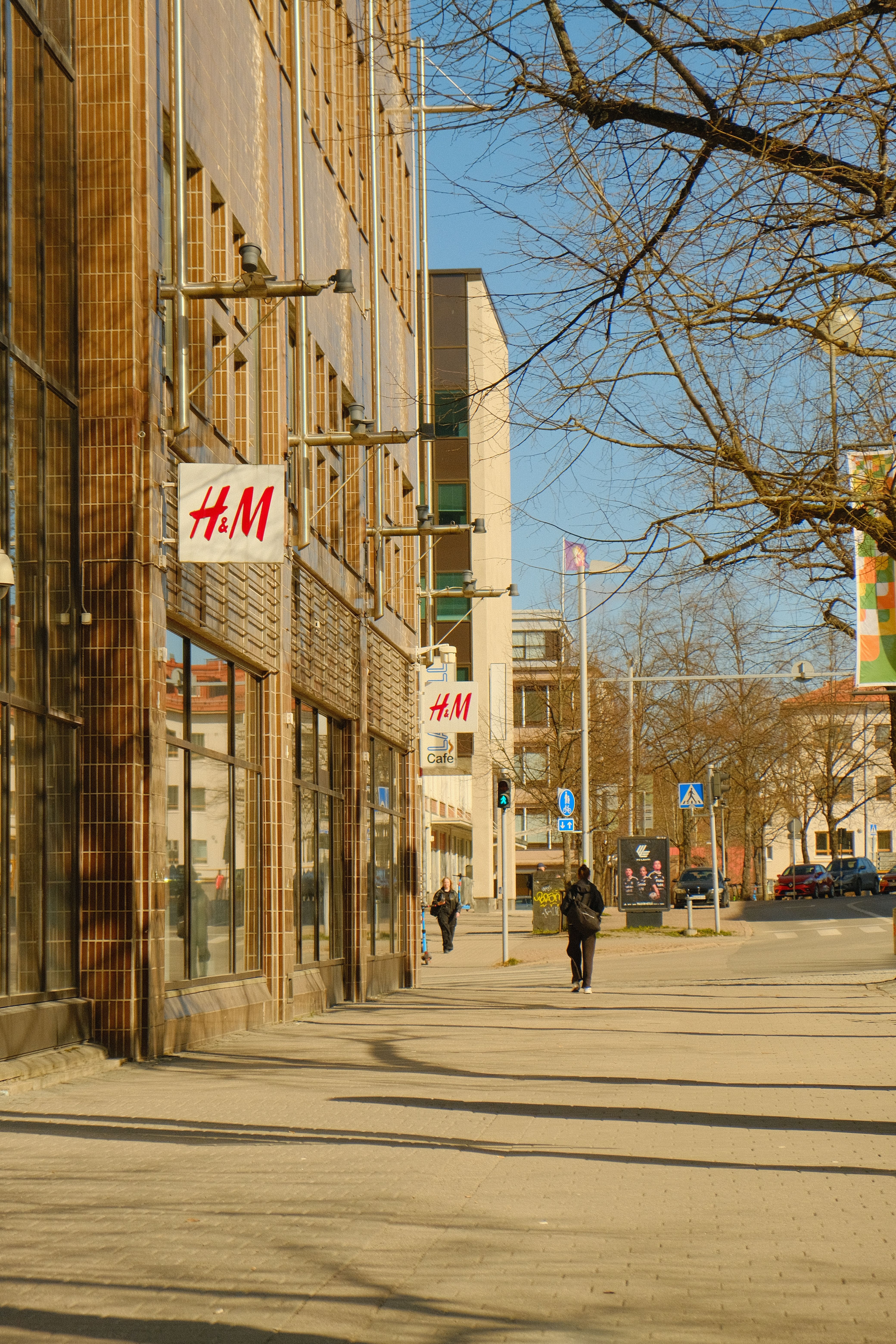 H&M store on a sunny street in Lahti, Finland, capturing urban life.