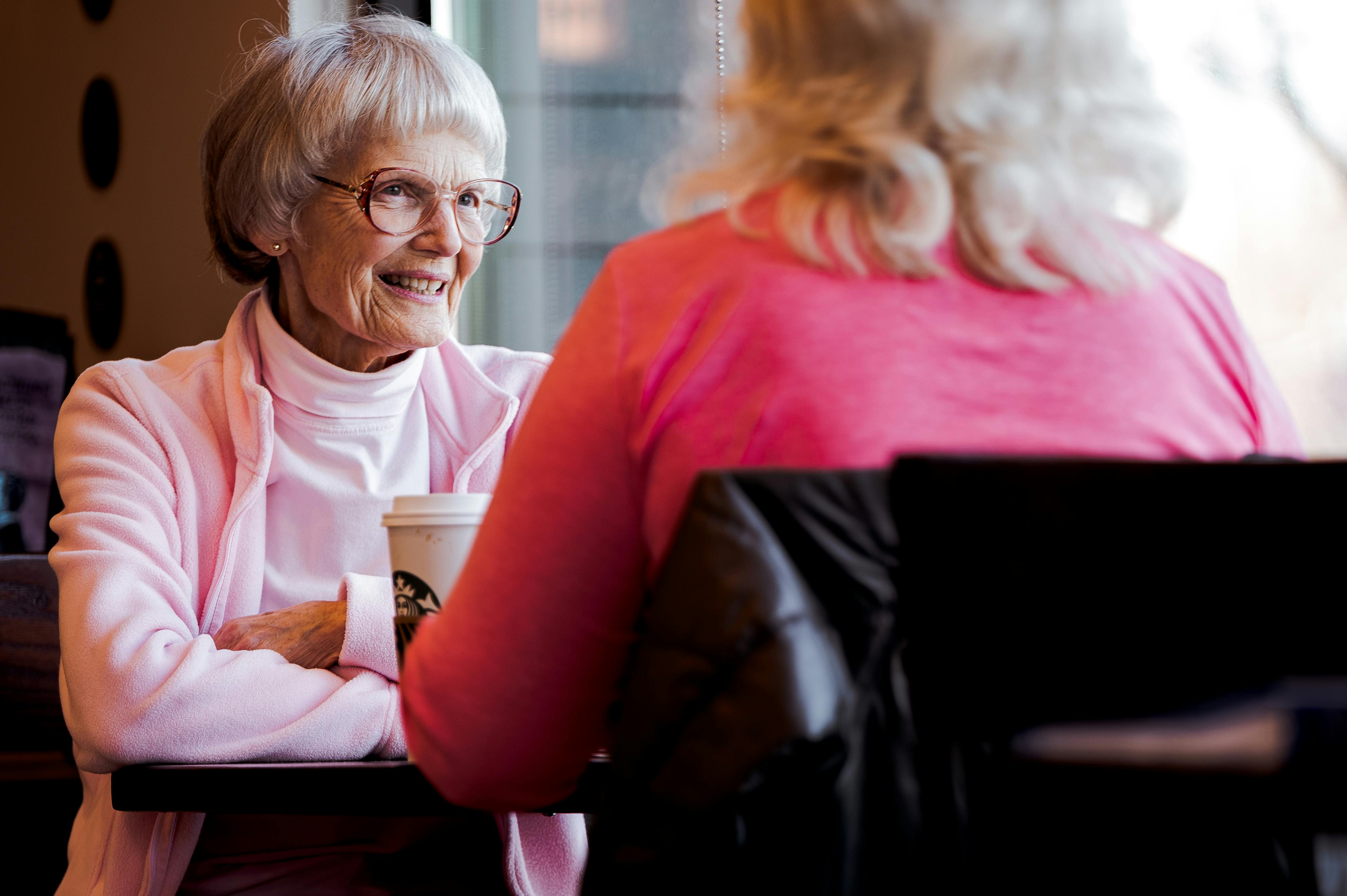 Old woman sitting while talking with another woman. | Photo: Pexels