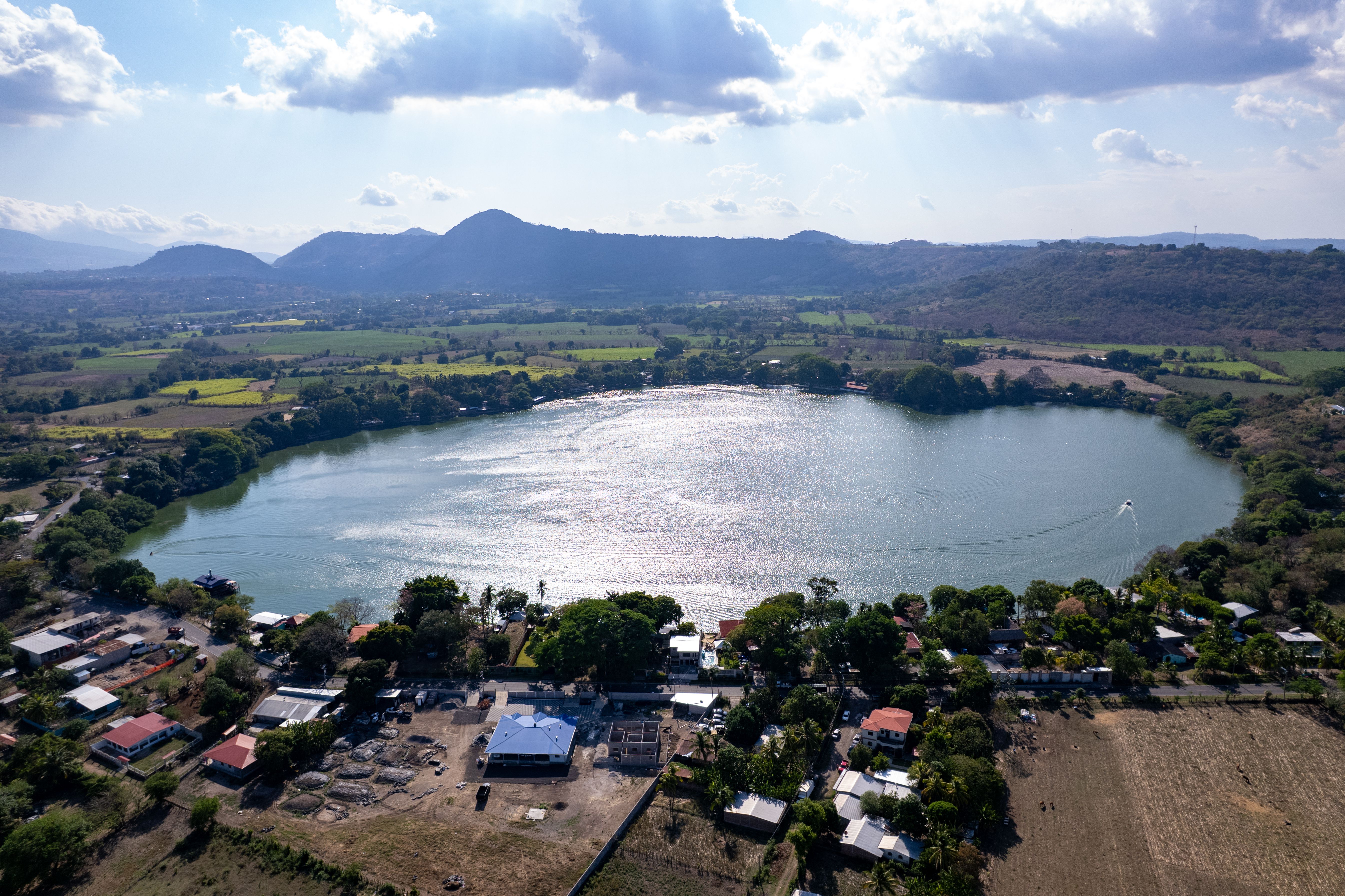 Breathtaking aerial shot of Apastepeque Lake, surrounded by lush landscapes in San Vicente, El Salvador.