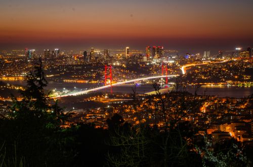 Free Vibrant cityscape of Istanbul featuring the illuminated Bosphorus Bridge at night. Stock Photo