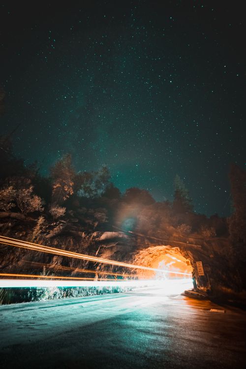 Free Vibrant stars illuminate a tunnel entrance, enhanced by dynamic light trails, creating a cosmic scene. Stock Photo