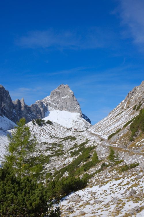 Free Scenic view of a snowy mountain range under a clear blue sky in Schwaz, Tirol, Austria. Stock Photo