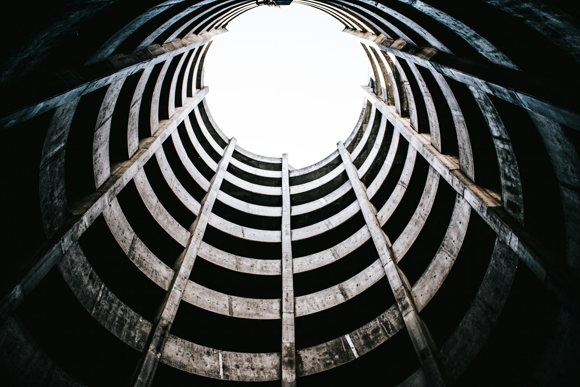 View from below of an abandoned concrete spiral parking structure in urban San Francisco.