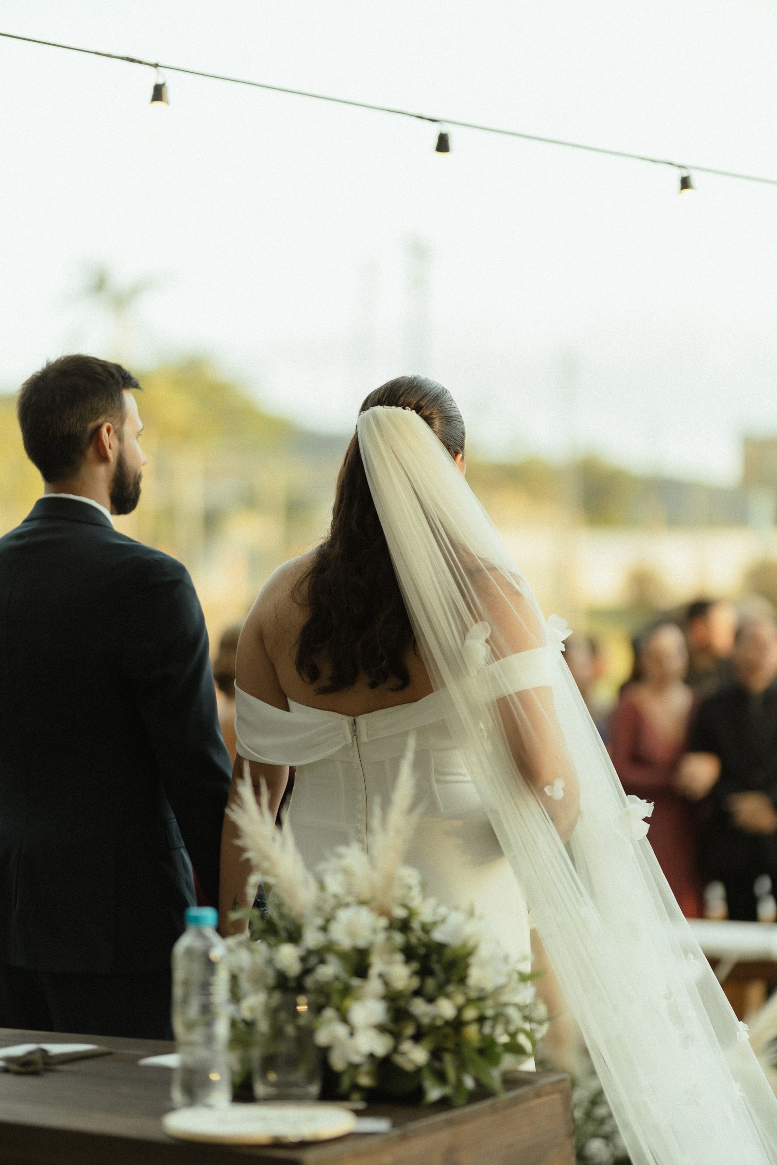 Couple at an outdoor wedding ceremony with floral decor