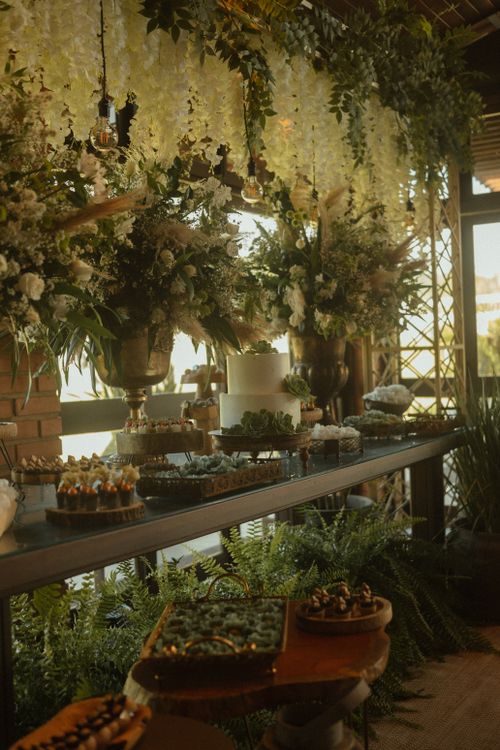 Free Beautiful rustic wedding reception setup with floral arrangements and cake. Stock Photo