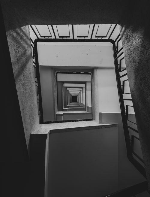 Free Black and white abstract view of a spiraling staircase creating a captivating geometric pattern in Pune, India. Stock Photo