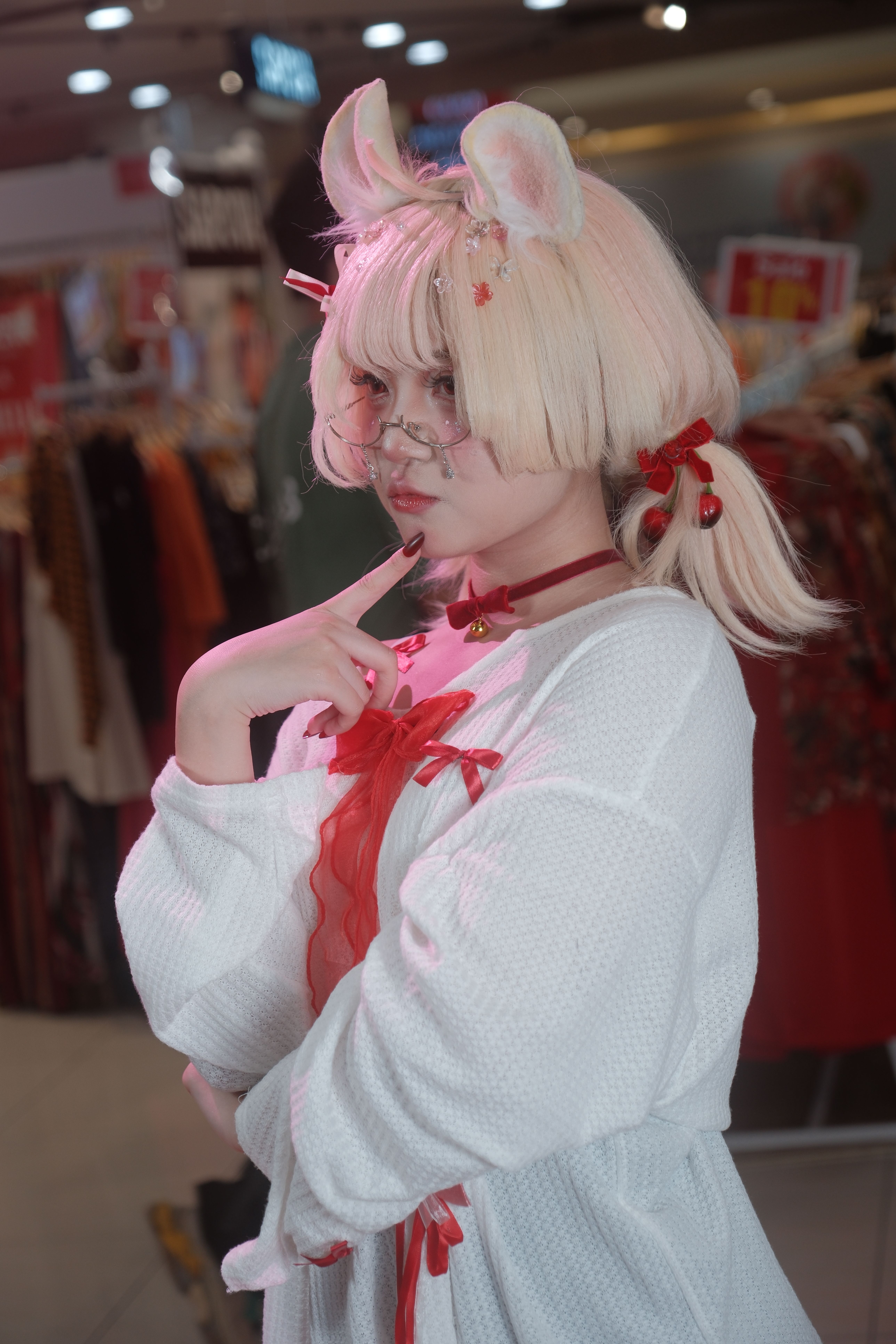 A cosplayer in a playful outfit posing indoors at a mall in Vietnam.
