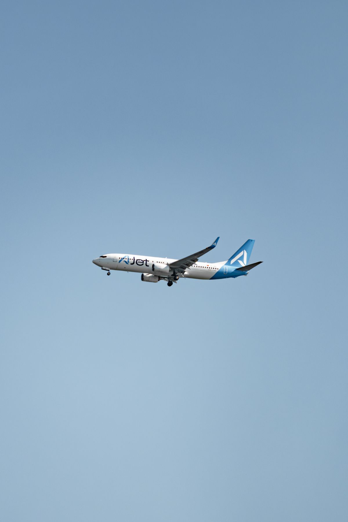 Commercial Airplane Flying Against Clear Blue Sky · Free Stock Photo