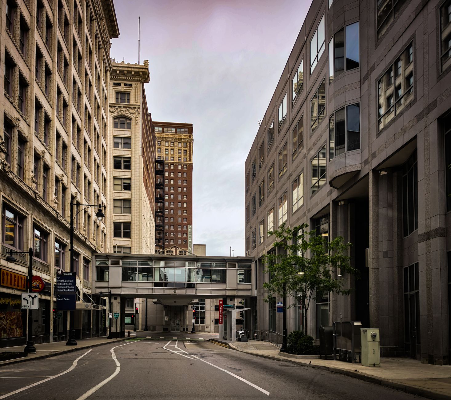Empty street in downtown Kansas City, Missouri featuring historic and modern architecture.