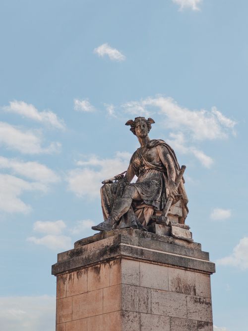 Free A striking ancient statue captured against a blue sky, showcasing artistry and detail. Stock Photo