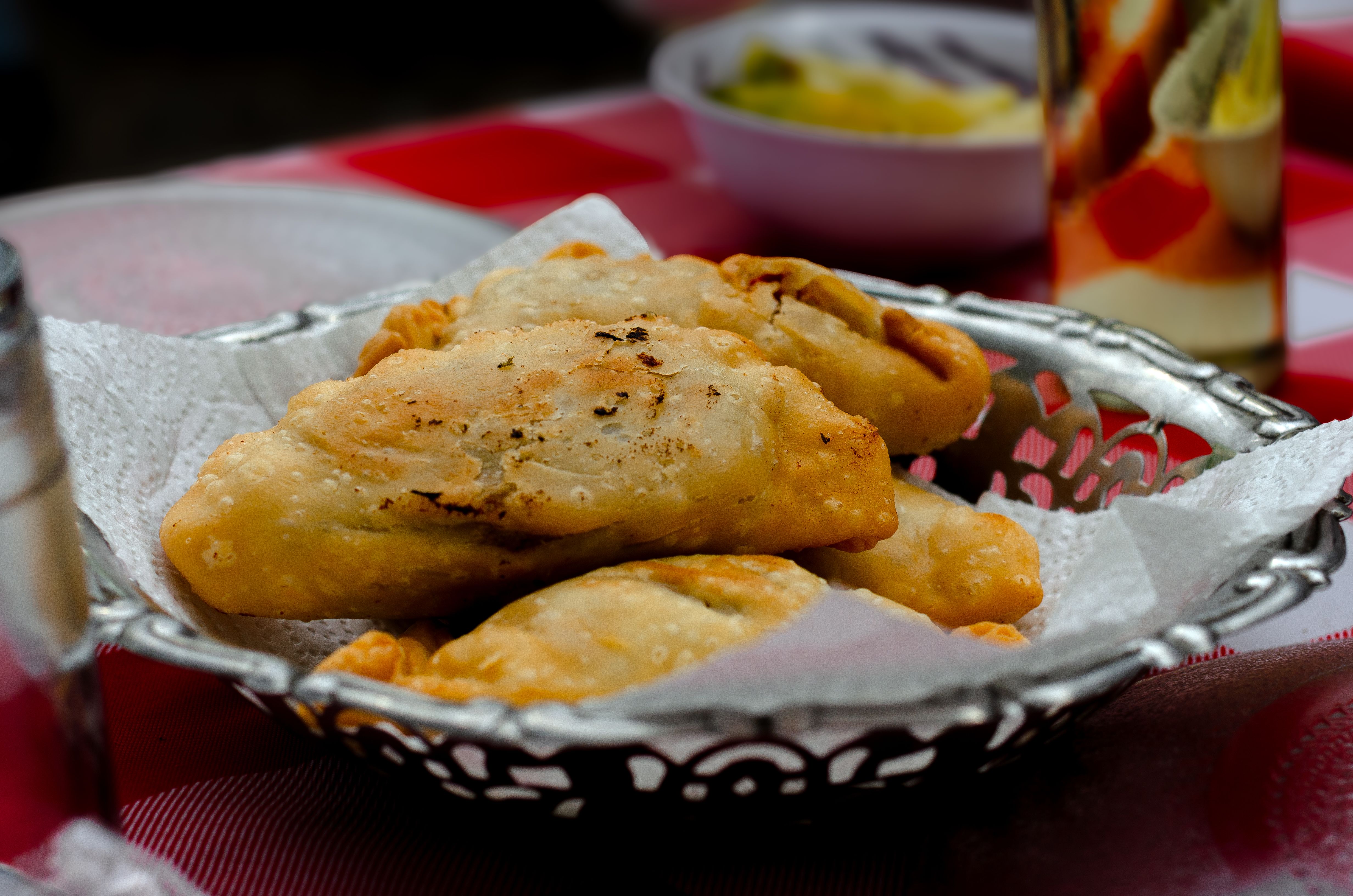 Freshly baked Argentine empanadas served on a decorative plate in Buenos Aires.
