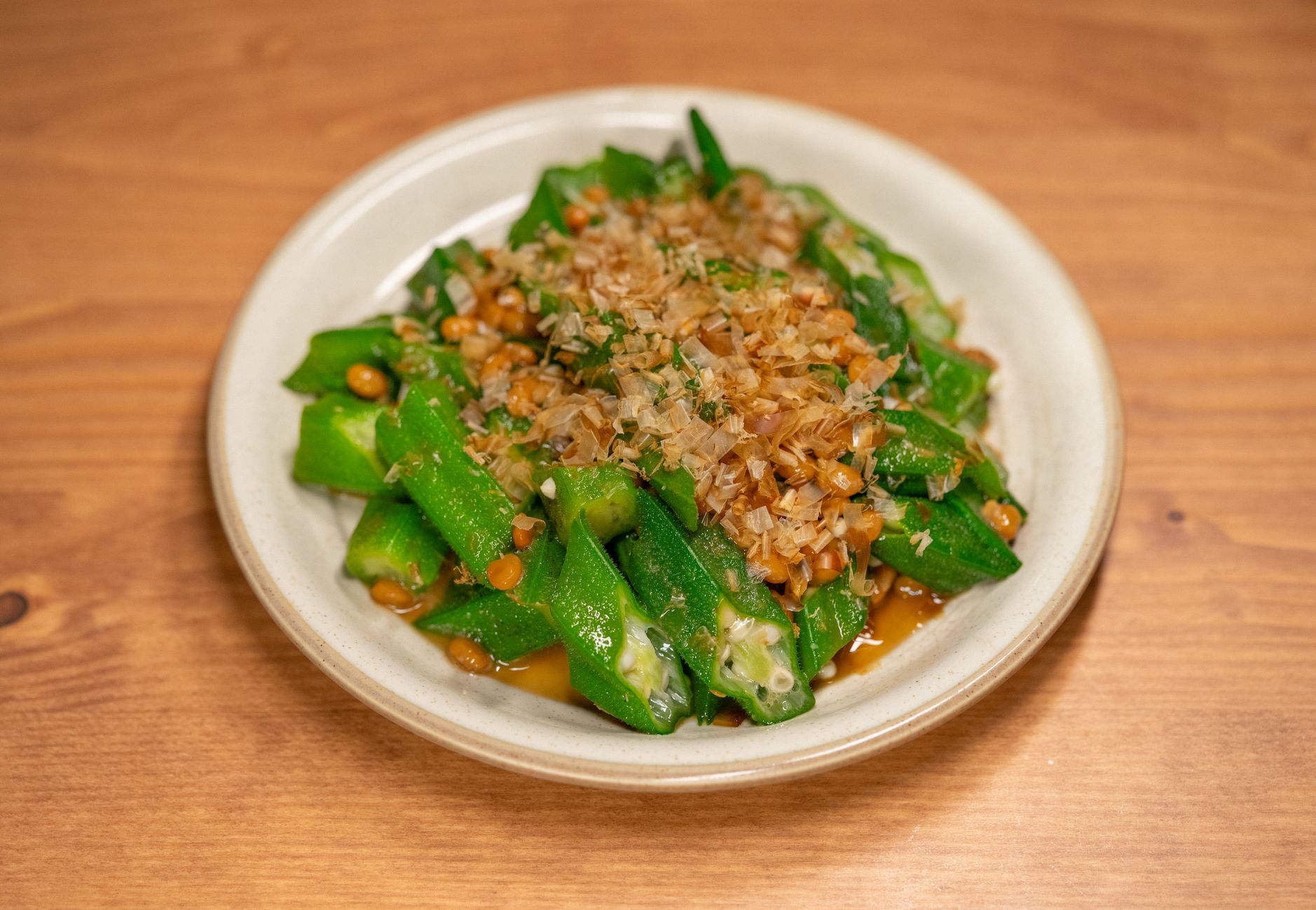 nattokinase protocol book — Savory plate of okra and natto topped with bonito flakes, perfect for Asian cuisine lovers.