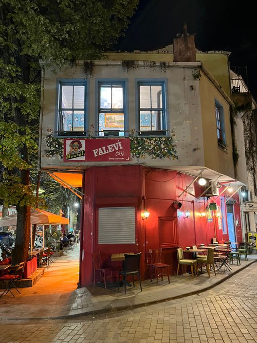 Free Cozy corner cafe called Faleti illuminated at night in Istanbul, Turkey, offering a warm ambiance. Stock Photo