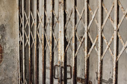 Free Close-up of a vintage rusty metal gate showcasing intricate design and weathered texture. Stock Photo