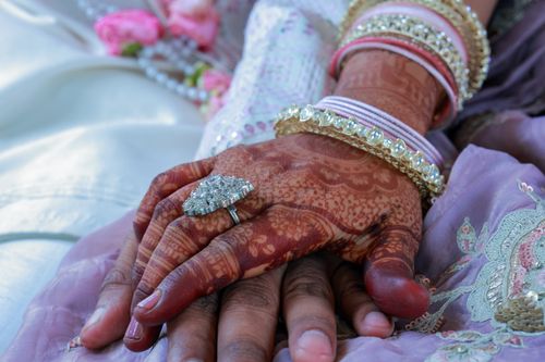 Free Detailed capture of hands with henna tattoos and traditional jewelry, symbolizing love and unity. Stock Photo