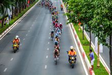 Aerial view of a road cycling race through a city — photo by Bao Minh on Pexels