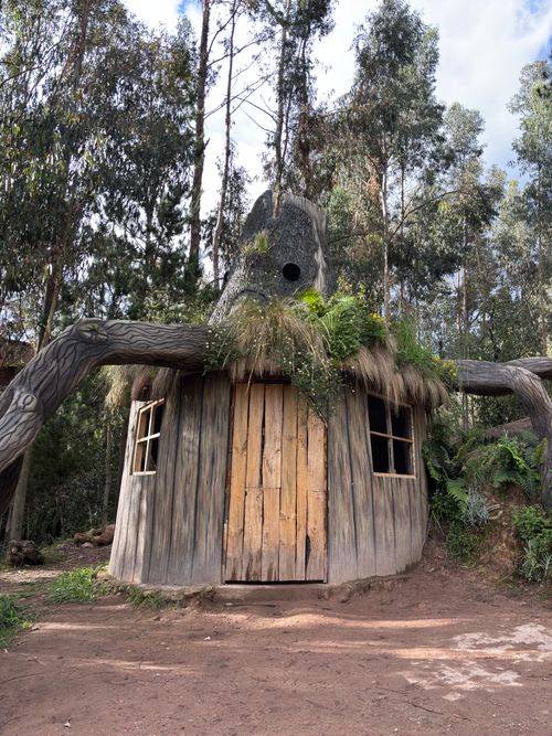 Free Quaint tree-shaped house amongst lush greenery in Quinua, Ayacucho, Perú. Stock Photo
