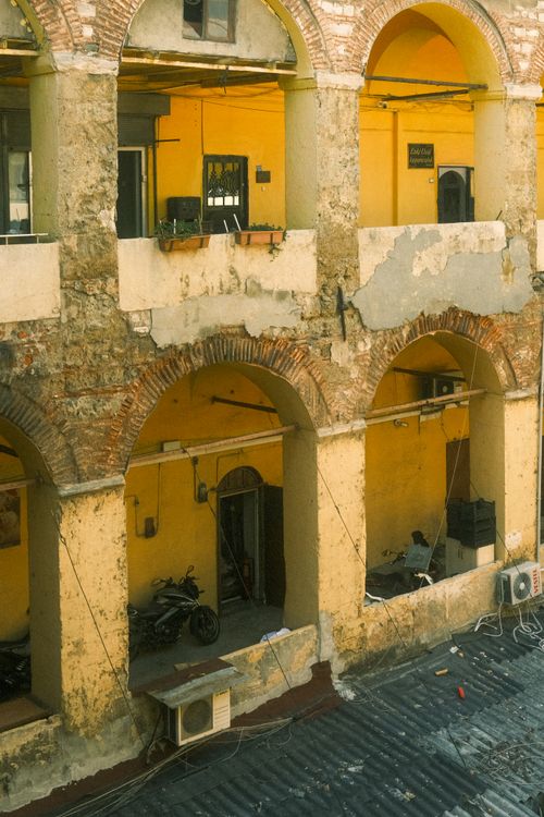 Free A rustic arcade in İstanbul showcasing aged architecture and vibrant yellow walls. Stock Photo