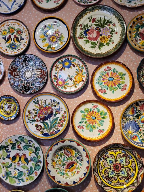 Free Vibrant collection of hand-painted ceramic plates with floral patterns. Stock Photo