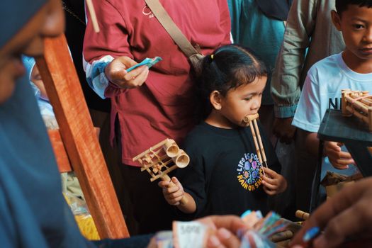 Kids playing Angklung at a cultural event in Jawa Barat, Indonesia.
