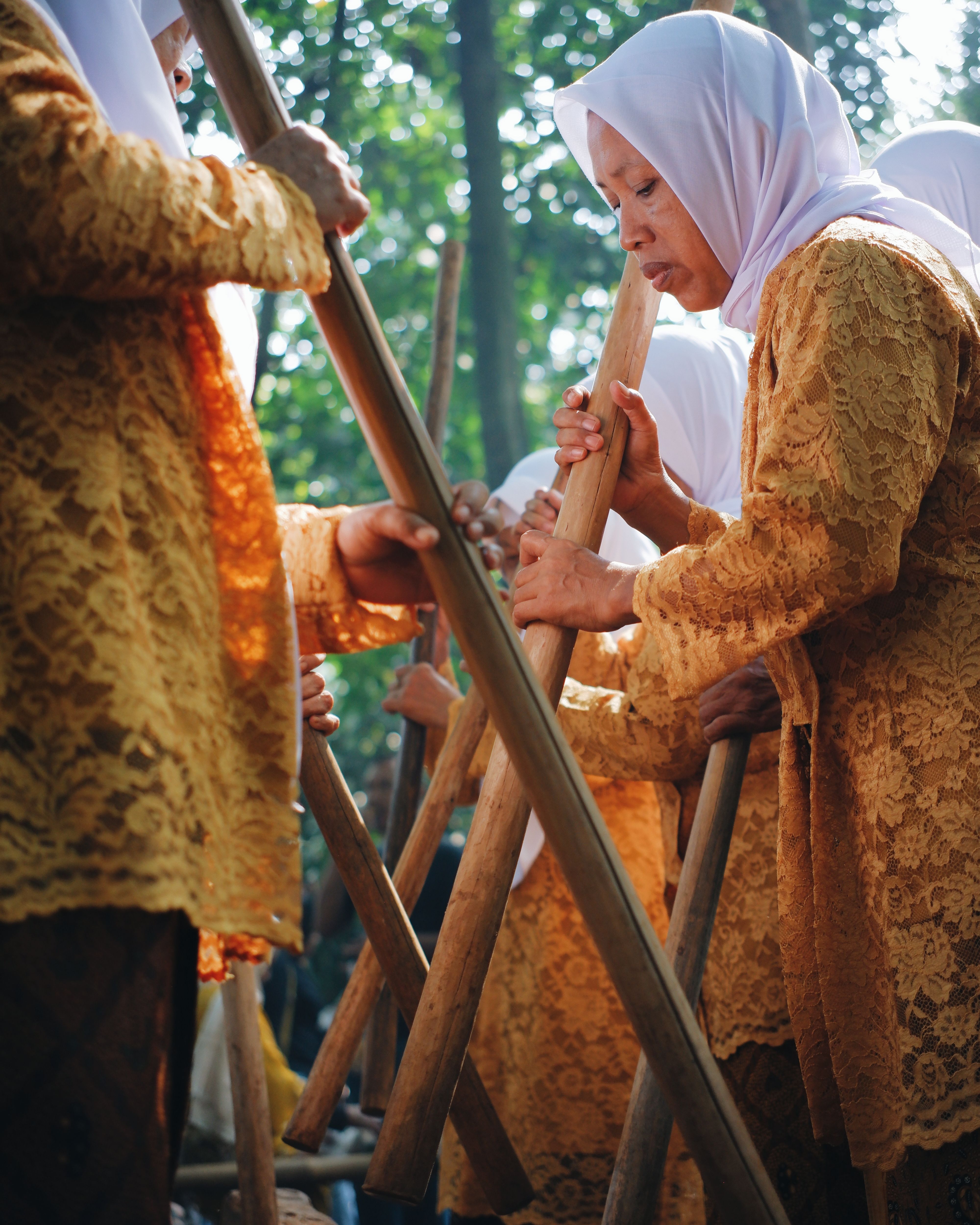 Group of women performing traditional bamboo dance in West Java, Indonesia.