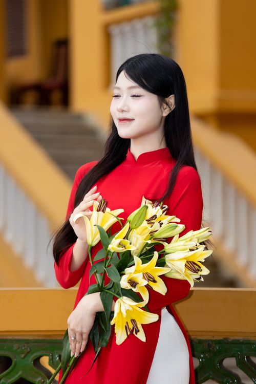 Elegant Woman in Red with Lilies Outdoors · Free Stock Photo