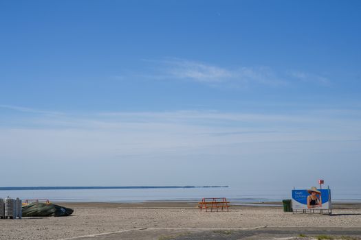 Peaceful landscape of the empty beach at Pärnu County, Estonia under a bright blue sky.