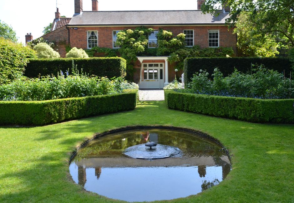 Garden fountain surrounded by lush greenery