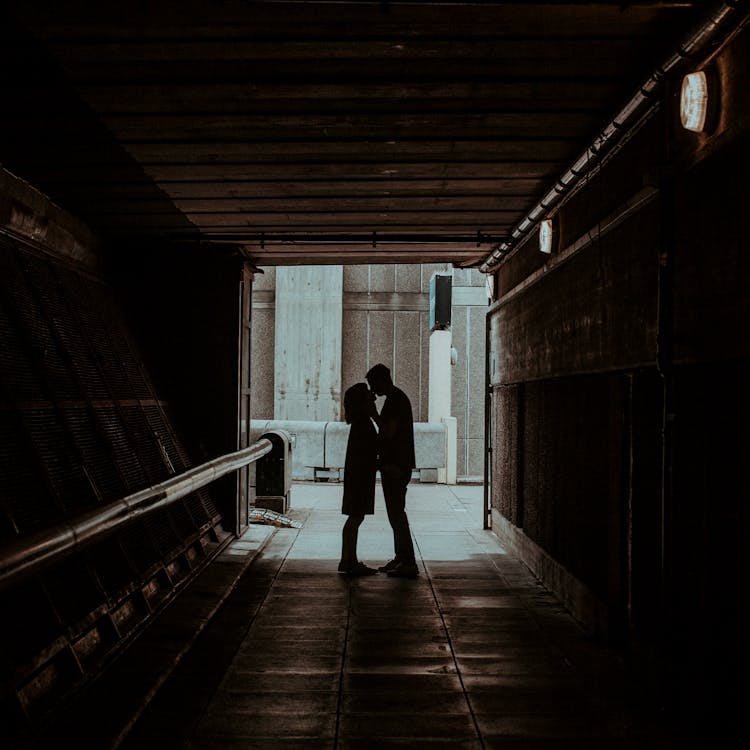 Photo of Couple Kissing in Hallway